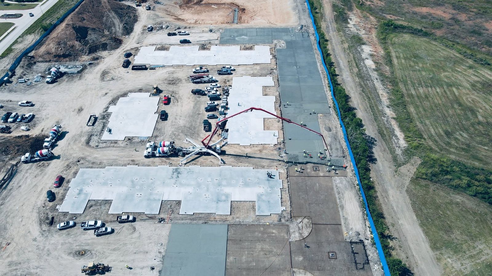 Drone view of a S.T.A.R. boom placing a large slab in Houston