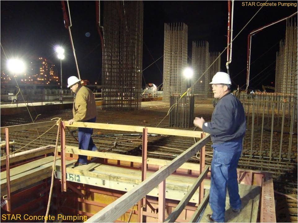 S.T.A.R. crew placing concrete under lights at night